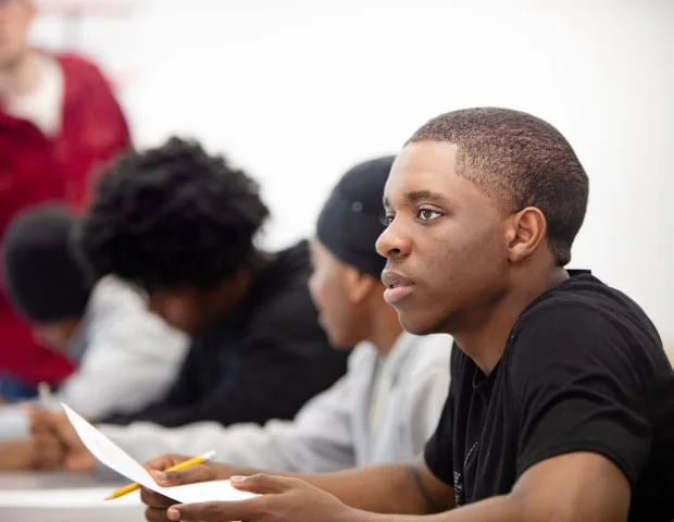 A student taking part in a classroom discussion